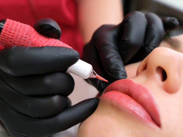 Close up of permanent lip makeup. lip tattoo. Beautiful lips